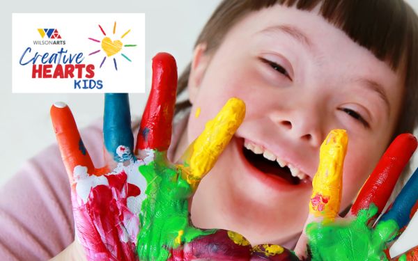 photo of a happy child with painted fingers